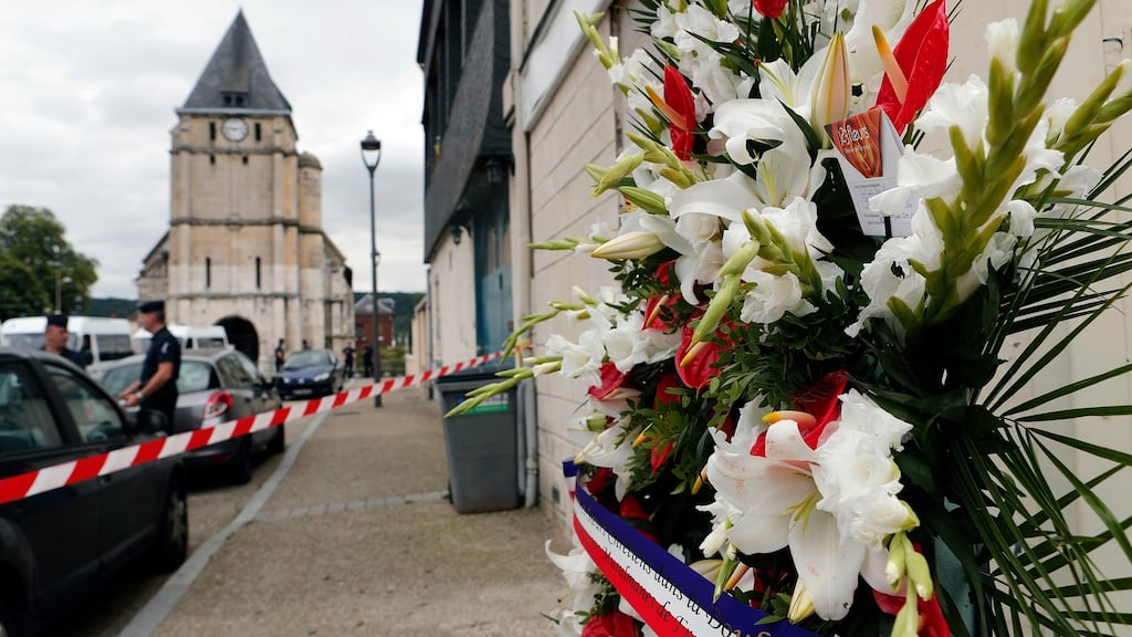 Flowers from the Muslims of France Association are left outside the church where a priest was killed on Tuesday in Saint-Étienne-du-Rouvray. Photograph: Francois Mori/AP