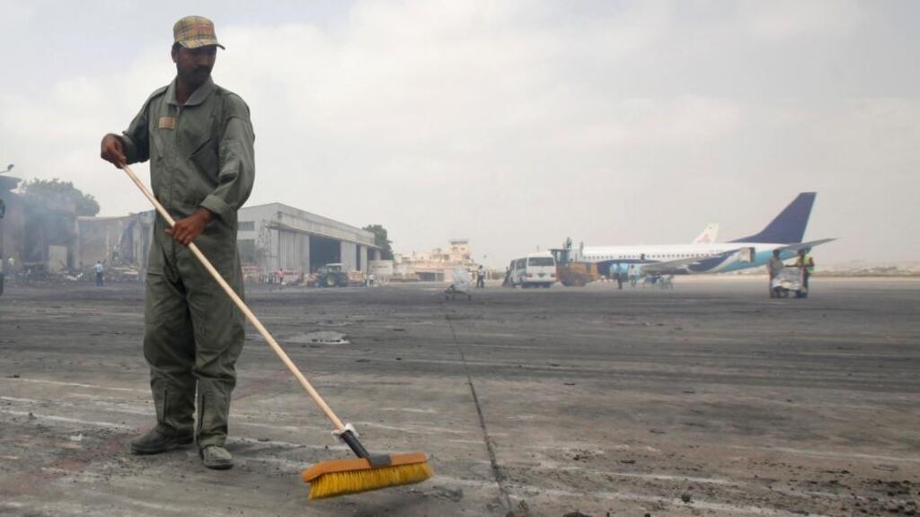 A man clears debris from the tarmac of Jinnah International Airport after last Sunday’s attack by Taliban militants which triggered an all-night battle leading to at least 27 deaths. Photograph: Athar Hussain/Reuters