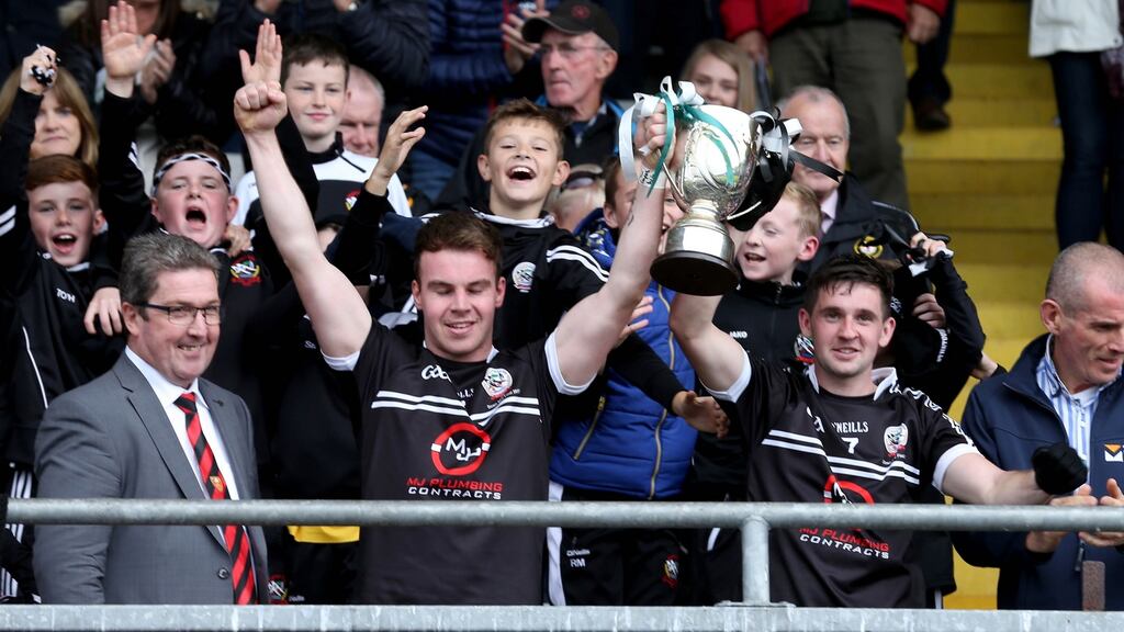 Kilcoo’s joint captain’s Darragh O’Hanlon and Darryl Branagan lift the trophy. Photograph: Inpho
