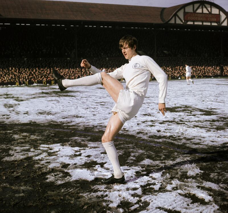 Striker Allan Clarke of Leeds United kicking the ball on a snow-covered pitch in 1970. Photo: Victor Drees/Getty
