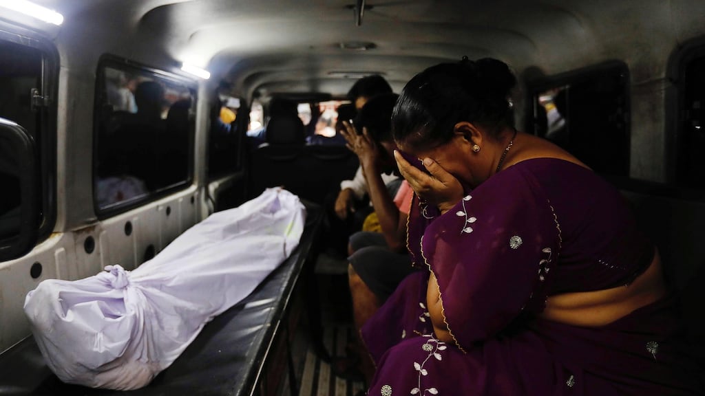 The mother of a stampede victim sits beside her son’s body as it is transported from a hospital in Mumbai, India, on Friday. Photograph: Danish Siddiqui/Reuters