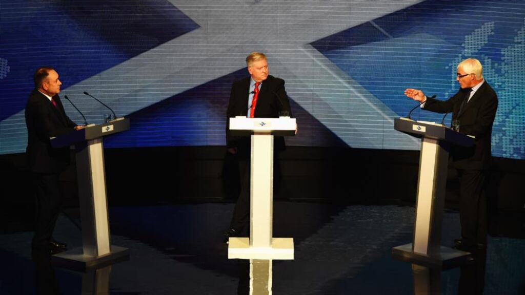 ‘Alistair Darling (right) unsettled his opponent, commentators seemed to agree, most effectively by repeatedly injecting doubt into the debate about Scotland’s post-separation currency.’ Above, with  Alex Salmond (left) First Minister of Scotland and  host Bernard Ponsonby from the Royal Conservatoire of Scotland, in the live TV debate. Photograph:  Jeff J Mitchell/Getty Images