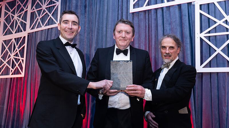 Graham Harding, sales director, Noyeks Newmans presents the sustainability award for a single building or development to Art McCormack and Stephen Donoghue, MosArt Architects