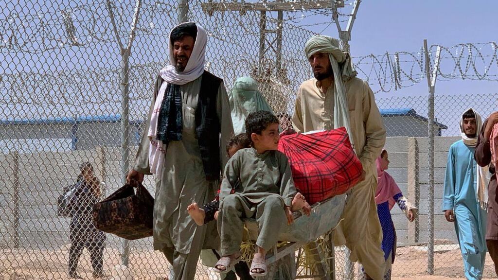 An Afghan family enter Pakistan through a border crossing point. Photograph: AP Photo