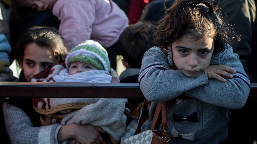Syrian refugees   at the closed  border gate   in Kilis, Turkey:  Local councils in Aleppo  estimate that  100,000-150,000 civilians could flee the city if Russian air strikes continue. Photograph:  Chris McGrath/Getty