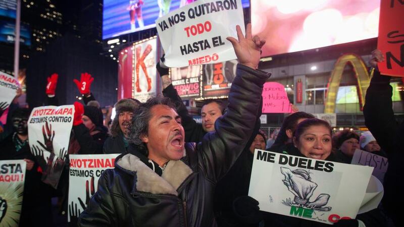 Protesters hold signs in Times Square, New York,  last night as they demonstrate against the Mexican government during US president Barack Obama’s speech on immigration reform. Photograph: Carlo Allegri/Reuters