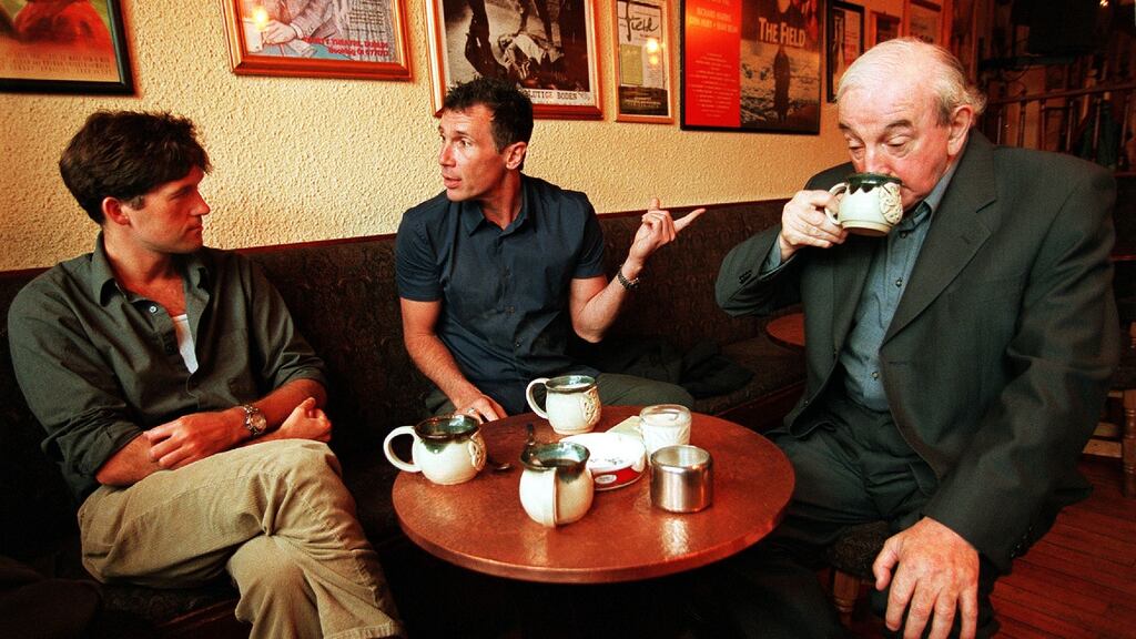 Michael Collins, left, winner of the Kerry Ingredients Book of the Year Award 2000, in conversation with Pulitzer prizewinning author Michael Cunningham and playwright John B Keane in John B’s bar during Listowel Writers Week. Photograph: Frank Miller