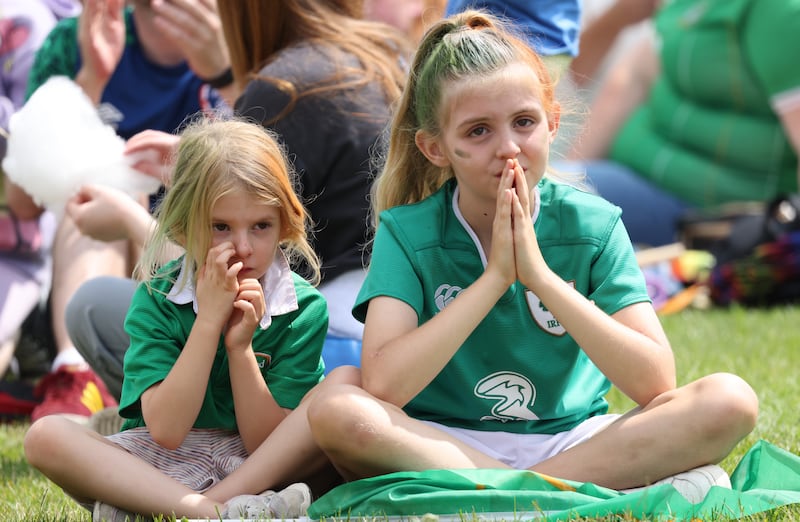 Amelia Halpin (right, aged 9) prays for an Irish goal with her sister Libby (6) during the Ireland Australia World Cup match screening at Irishtown Stadium in Ringsend. Photograph : Laura Hutton / The Irish Times