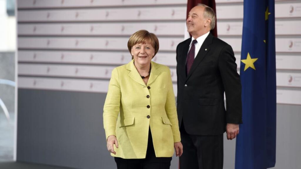 Latvian president Andris Berzins welcomes German chancellor Angela Merkel at the House of the Blackhead in Riga at the start of the EU Eastern Partnership Summit. Photograph: Alain Jocardalain/AFP/Getty Images