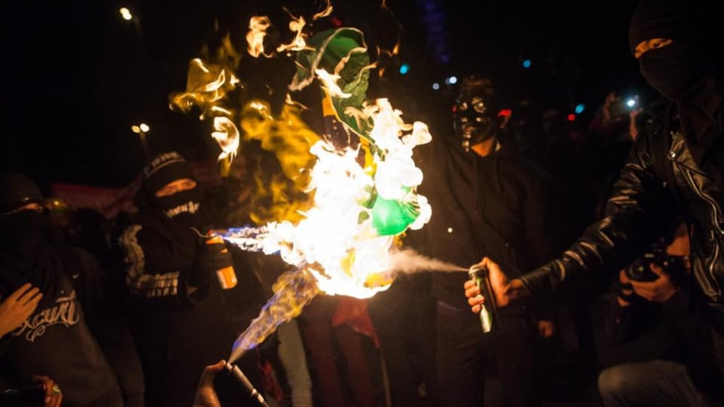 Flames of protest: demonstrators in São Paulo burn the Brazilian flag. Photograph: Victor Moriyama/Getty