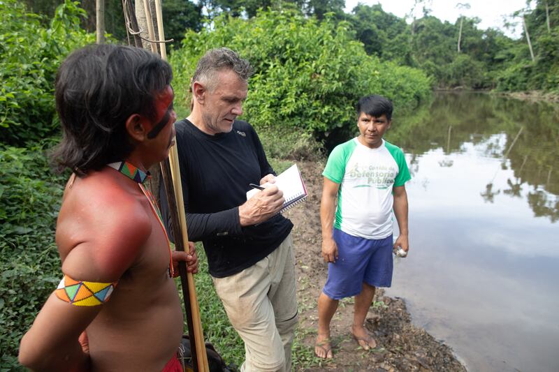 Journalist Dom Phillips talks to two indigenous men in Aldeia Maloca Papiú, Roraima State, Brazil, in November 2019. Photograph: Joao Laet/AFP via Getty Images