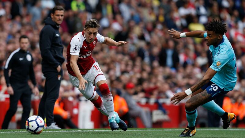 Mezut Ozil moves past Tyrone Mings during Arsenal’s comfortable win aganist Bournemouth. Photograph: Ian Kingto/AFP