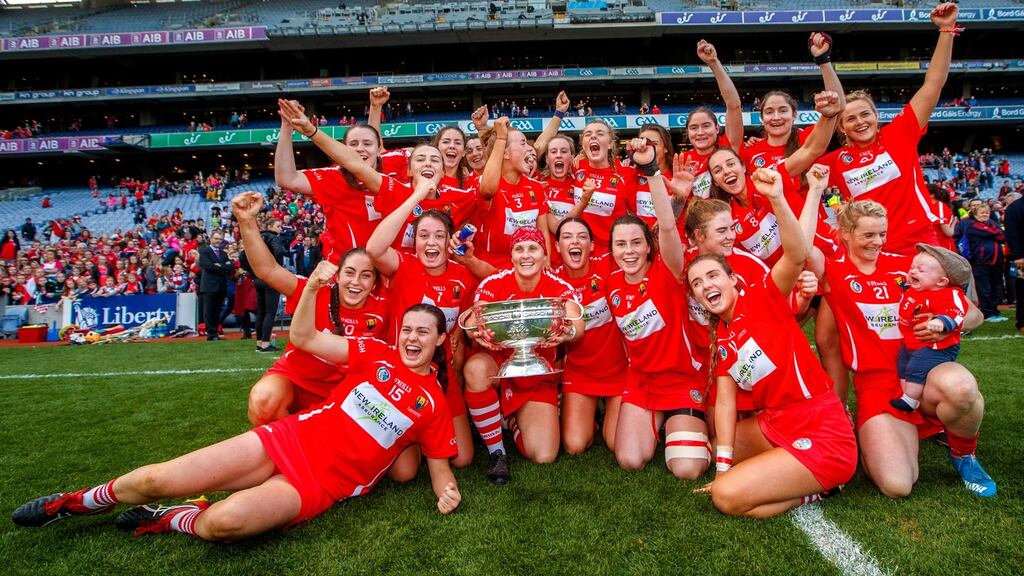 The Cork camogie team celebrate winning the All-Ireland title after beating Kilkenny. Photograph: James Crombie/Inpho