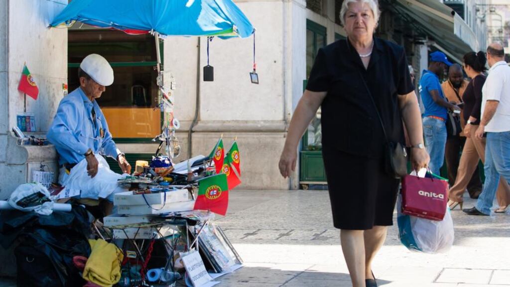 A street vendor selling Portuguese national flags on Rossio Plaza in Lisbon. There were fears the political turmoil could jeopardise the country’s bailout programme. Photographer: Mario Proenca/Bloomberg