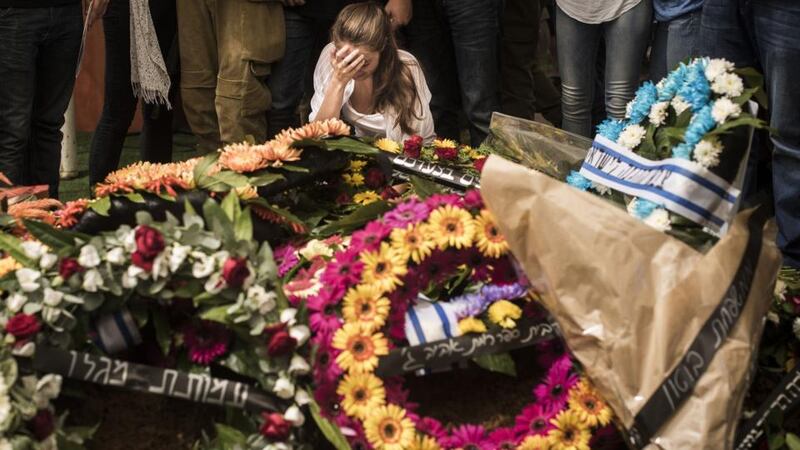 Family members mourn at the funeral of Staff Sgt Guy Algranati in Tel Aviv on Thursday. Israelis have come out in their thousands to attend soldiers’ funerals. Photograhph: Ilia Yefimovich/Getty Images