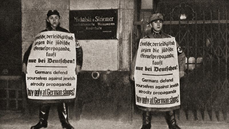 Two soldiers holding anti-Jewish propaganda in Berlin, Germany in 1933. Photograph: Universal History Archive/UIG via Getty Images