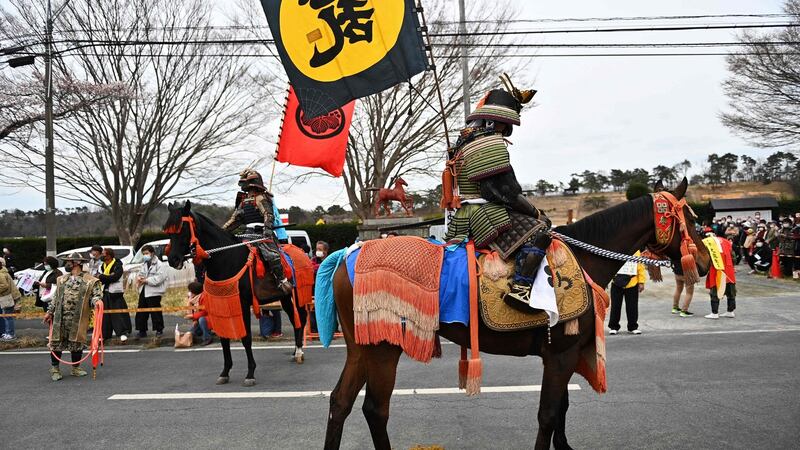 Horsemen wearing samurai armours attend a ceremony at Hibarigahara Festival Site, during the last leg of first part of the relay. Photo: Philip Fong/AFP via Getty Images