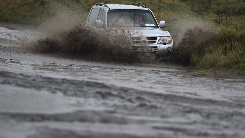 A driver steers through flood water caused by Storm Brian, along Bull Wall in Dublin, Ireland. Photograph: Clodagh Kilcoyne/Reuters