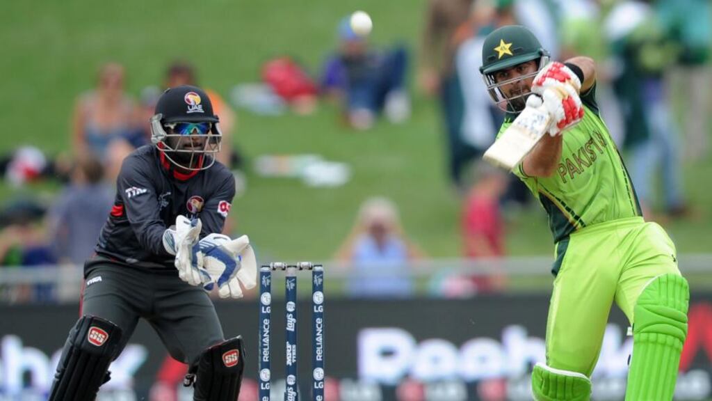 Pakistan batsman Ahmad Shahzad plays a shot as United Arab Emirates wicketkeeper Swapnil Patil watches during their Cricket World Cup Pool B match. Photograph: Ross Setford/AP