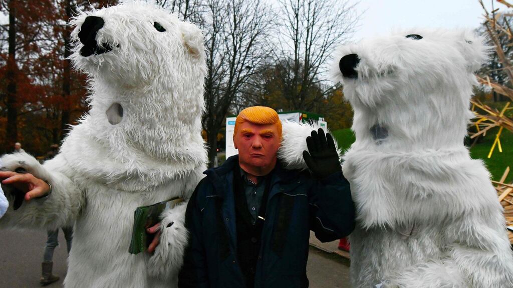 A man with a mask of US president Donald Trump during a performance created by Danish artist Jens Galschiot during the COP23 conference in Bonn. Photograph: Patrik Stollarz/AFP/Getty Images