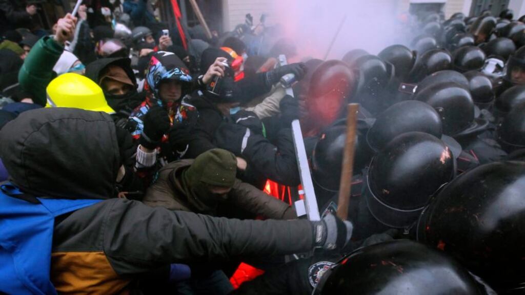 Protesters try to break through a riot police line near the presidential administration building in Kiev yesterday. Photograph: Sergey Dolzhenko/EPA