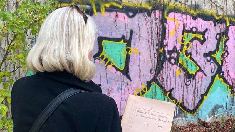 Eva Röser, who did not wish to have her face photographed, holds her Stasi file in Berlin. Photograph: Derek Scally