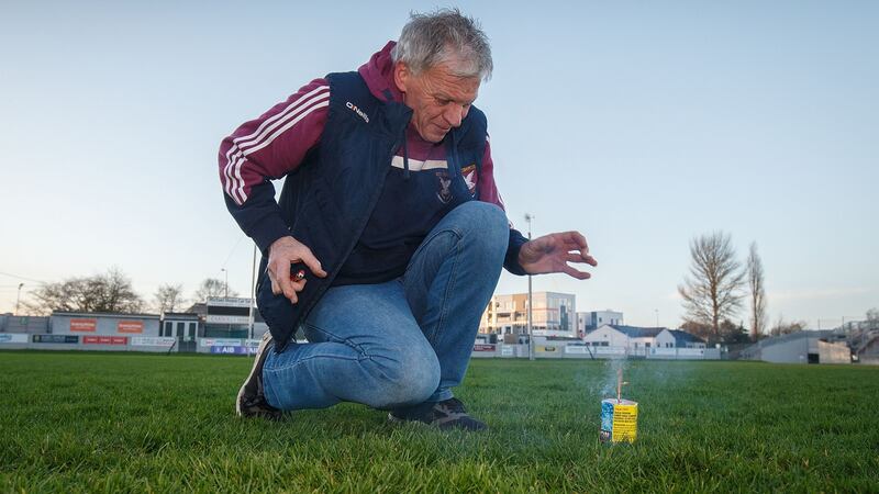 Tom McElligott sets off a firework on the pitch after the game. Photo: Oisin Keniry/Inpho