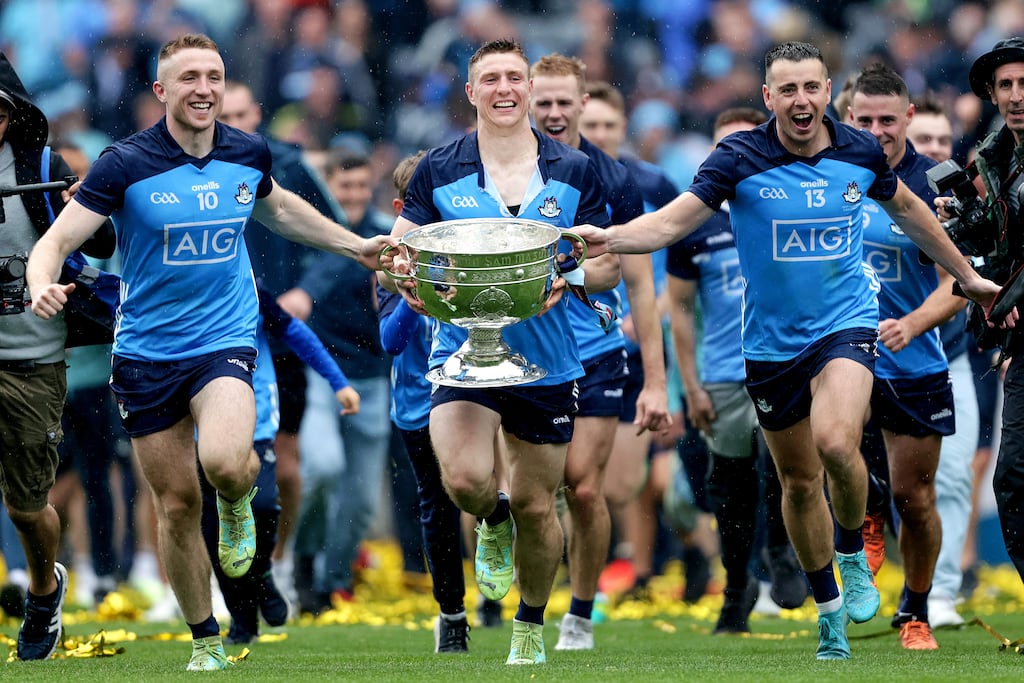 Dublin's Paddy Small, John Small and Cormac Costello celebrate with the Sam Maguire trophy. Photograph: Laszlo Geczo/Inpho