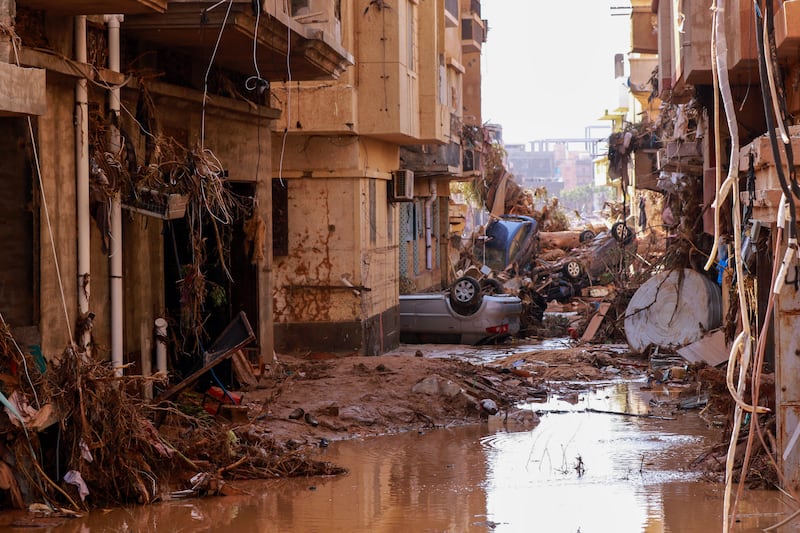 Overturned cars lay among other debris in a street in Derna. Photograph: AFP via Getty