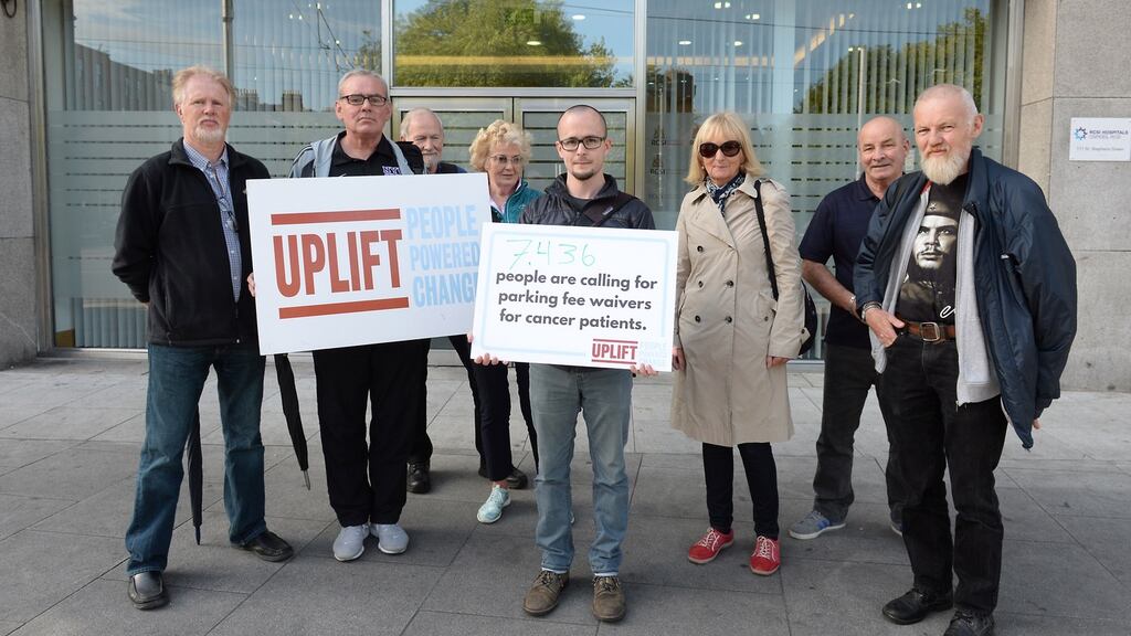 Roderick Campbell (centre) from Uplift photographed outside the RCSI HQ before delivering a petition to the RCSI Hospitals over parking fees. Photograph: Brenda Fitzsimons/The Irish Times