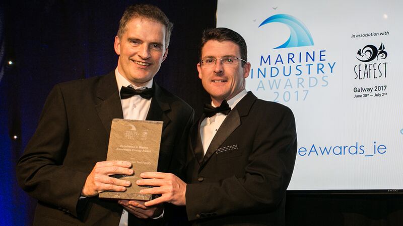 Eamonn Confrey, DCCAE, the Principal Officer of the Decarbonisation Division, presents the Excellence in Marine Renewable Energy Award to Jimmy Murphy, Lir National Ocean Test Facility.
