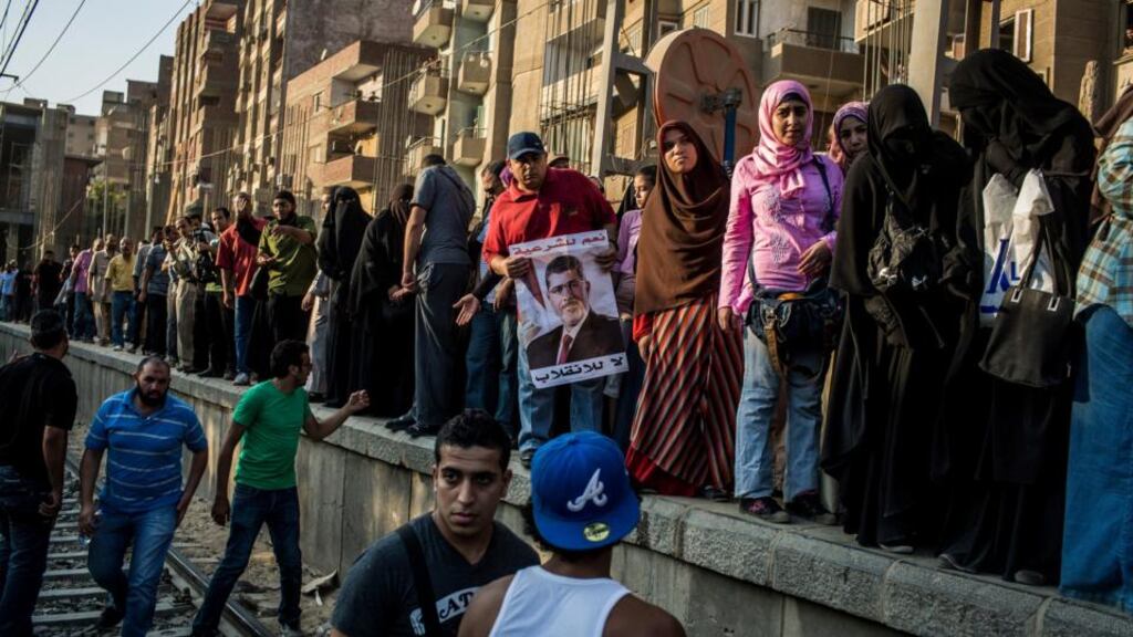 Supporters of Mohammed Morsi, the ousted Egyptian president, wait for the Metro in the Maadi neighborhood to travel closer to Cairo city centre to continue their demonstration yesterday. Photograph: Bryan Denton/The New York Times