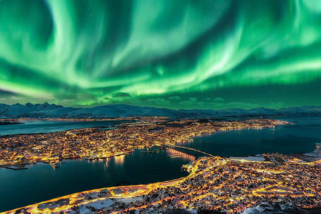 The aurora borealis (Northern Lights) dancing over Tromsø in Norway, one of the largest urban areas in the Arctic Circle