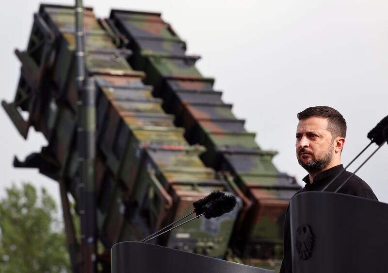President Volodymyr Zelensky stands in front of a Patriot air defence missile system. Photograph: Jens Buettner/dpa/AP