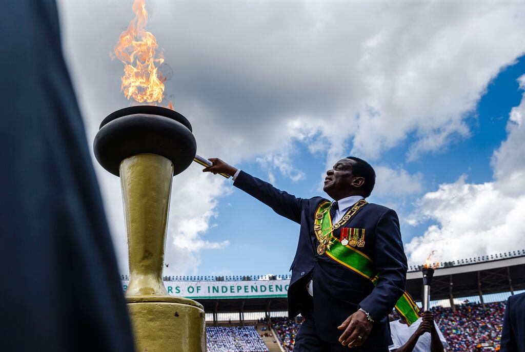 Zimbabwe's President Emmerson Mnangagwa lights the eternal flame of freedom during Zimbabwe independence day celebrations at the national sports stadium in Harare. Photograph: Jekesal Njikizana/AFP via Getty Images