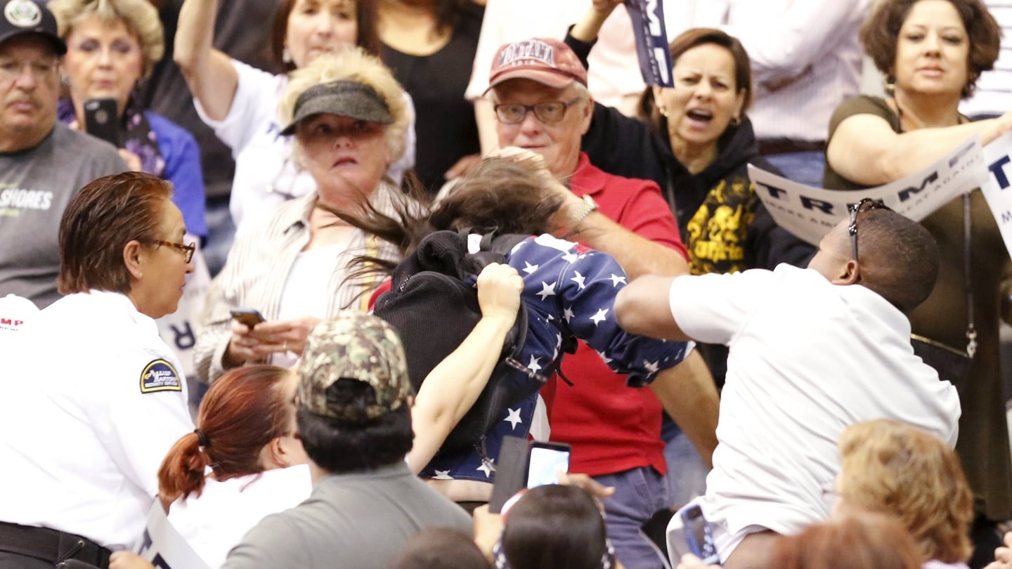 A member of the audience (right) throws a punch at a protestor as Republican presidential candidate Donald Trump speaks during a campaign event in Tucson. Photograph: Reuters
