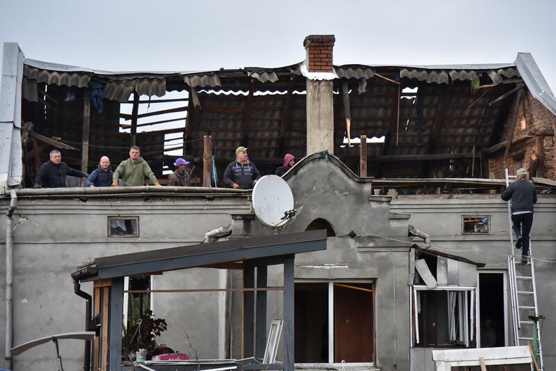 Residents stand in the attic of a damaged house following an air attack in Lapaivka, Lviv region on October 5th. Photograph: Stringer/ AFP via Getty Images