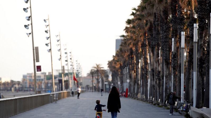 A child and mother take a stroll along the promenade in Barcelona, Spain on Saturday. Photograph: Alejandro Garcia/EPA