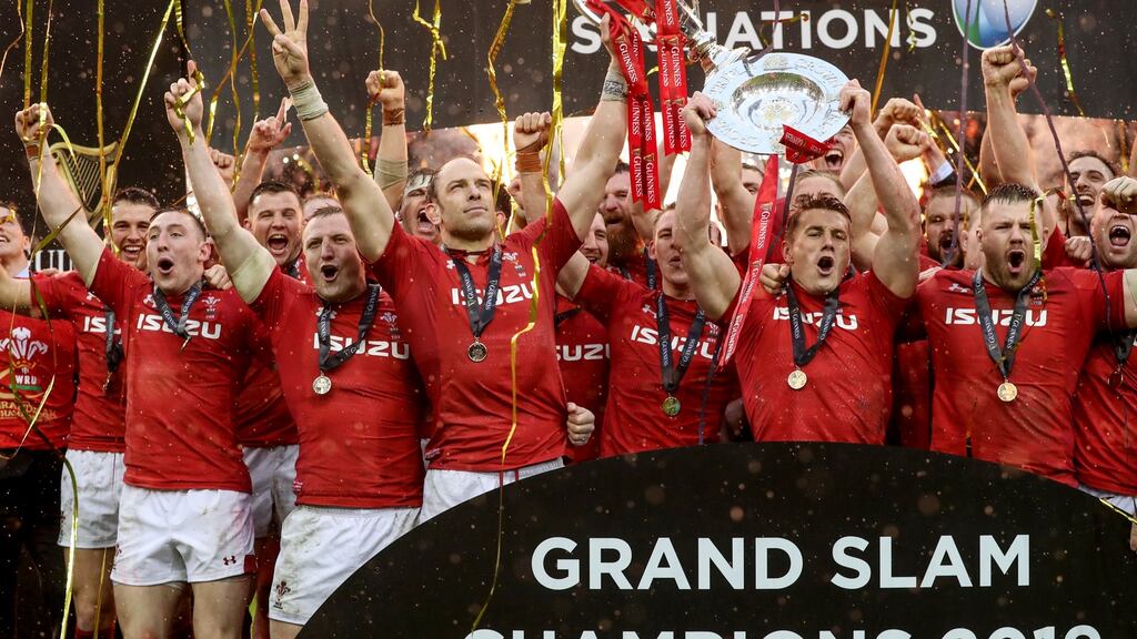 Alun Wyn Jones lifts the Guinness Six Nations trophy as Wales celebrate clinching the Grand Slam in Cardiff. Photograph: Dan Sheridan/Inpho