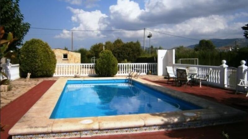 This finca sits in fenced land with a swimming pool and a football pitch.