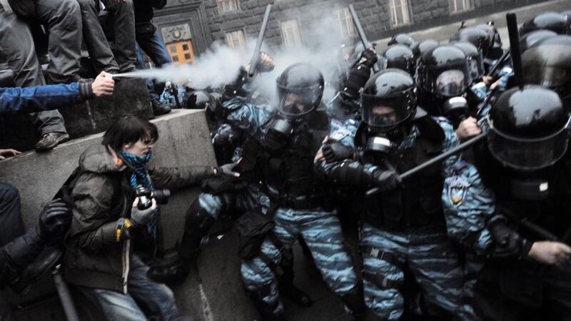 Clash: protesters use tear gas against riot police in Kiev in November 2013. Photograph: Genya Savilov/AFP/Getty