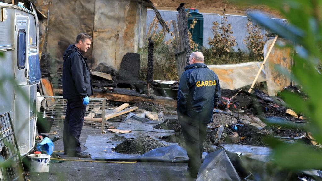 Gardaí inspect the scene of a fatal fire at a halting site on Glenamuck Road in Dublin last October. Dún Laoghaire-Rathdown County Council has proposed a new site for those affected by the blaze on the same road. Photograph: Nick Bradshaw.