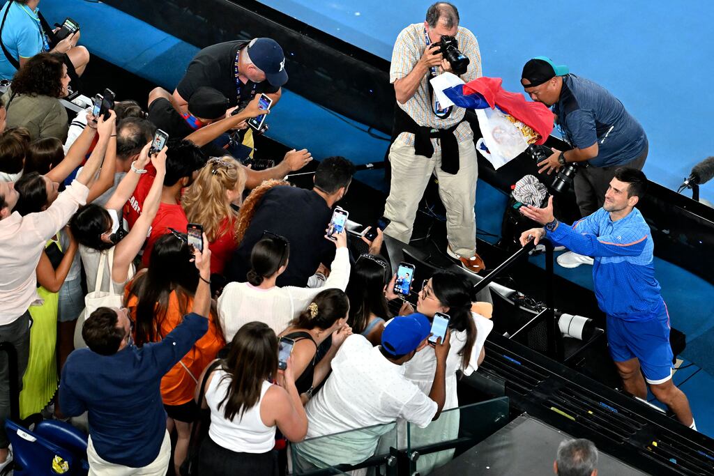Novak Djokovic throws back the Serbian national flag towards his supporters after his victory against Tommy Paul in the semi-finals of the Australian Open. Photograph: Paul Crock/AFP via Getty Images