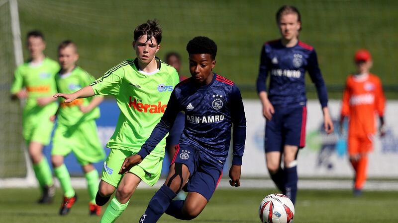 Ajax’s Silvano Vos is tracked by Darragh Murtagh of DDSL. Photograph: Tommy Dickson/Inpho