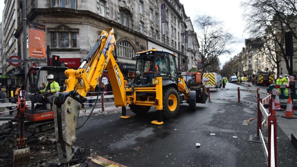 Workers dig up a section of road outside Holborn underground station following an electrical fire in the service tunnels under the pavement in London. There were rush hour delays as a major road in central London remained closed on after an underground electrical fire, which took 12 hours to bring under control and saw the evacuation of more than 2,000 people. Ben Stall/AFP