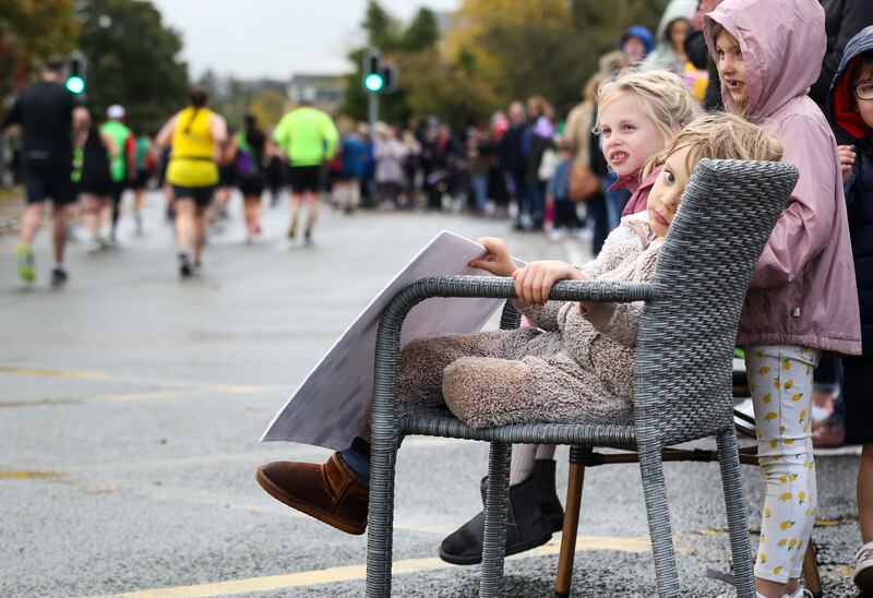 A young spectator waits for his dad to run past. Photograph: Nick Elliott/Inpho