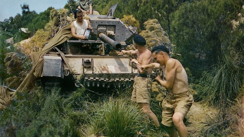 A crew from the 16th/5th Lancers, 6th Armoured Division, cleaning the gun barrel of their Crusader tank at El Aroussa in Tunisia, May 1943. Photograph: Ted Dearberg/IWM/PA