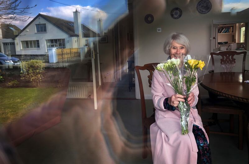 1st Portrait: COCOONING ON MOTHER’S DAY: Ellen Creed, Dublin, with the flowers her daughter left outside her door for Mother’s Day. Photograph: Bryan O’Brien / The Irish Times