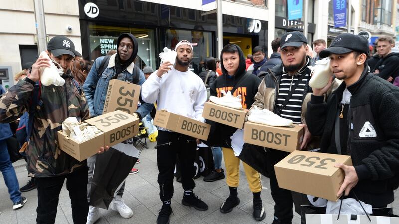 A group of men with their Yeezy Boost 350 by Adidas/Kanye West at JD Sports, Mary Street, Dublin in April. Photograph: Dara Mac Dónaill
