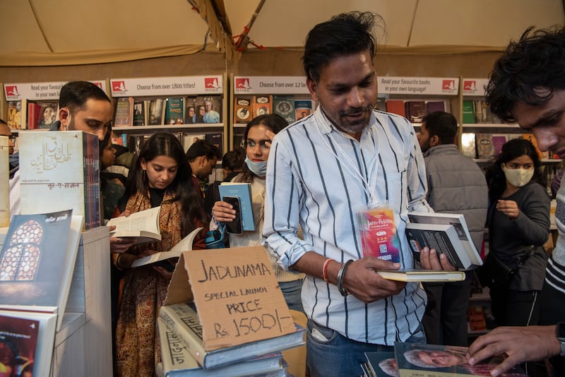 Attendees browse a book stall during Jashn-e-Rekhta, an Urdu poetry festival in New Delhi. Photograph: Saumya Khandelwal/New York Times